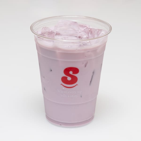 A clear plastic cup filled with a light purple drink and ice, featuring a red 'S' logo.